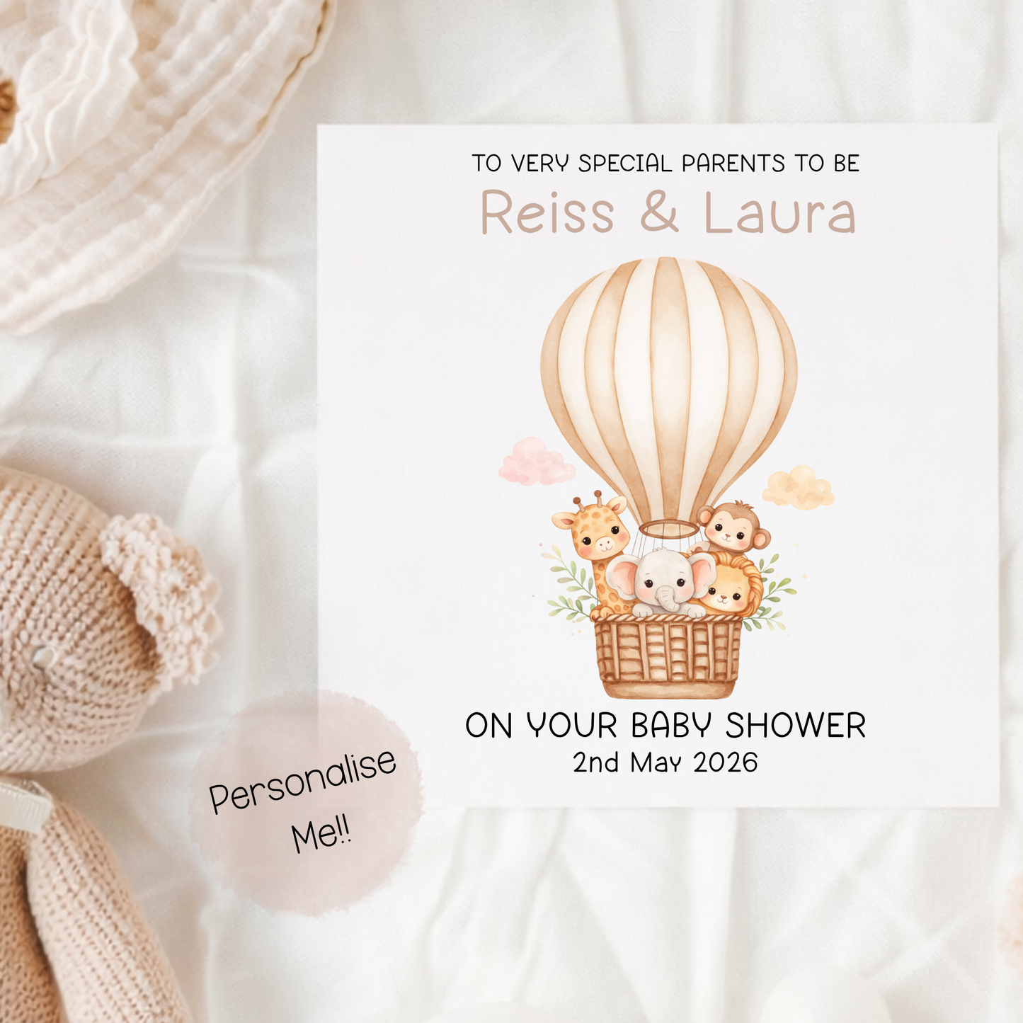 Baby shower invitation with hot air balloon and animals on a soft fabric background