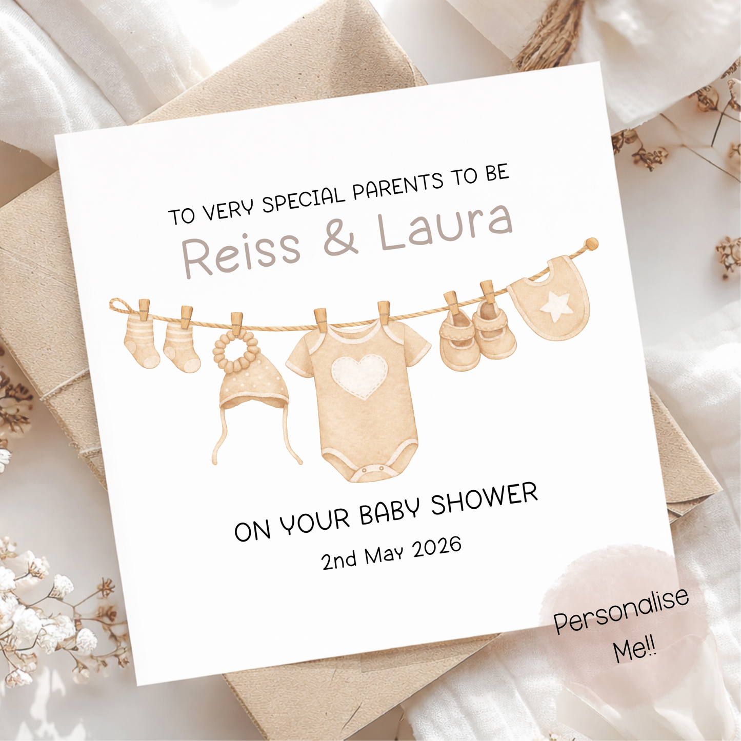 Baby shower invitation card with baby clothesline illustration on a soft background