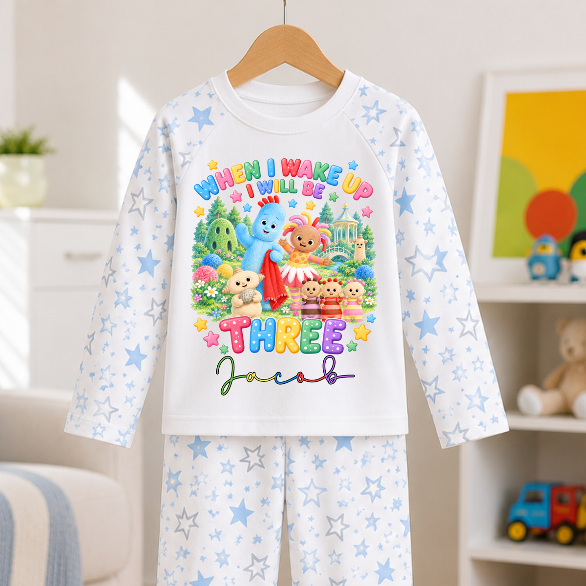 Personalised In the Night Garden birthday pyjamas with custom name and age, colourful character design and blue and white star-patterned sleeves and trousers.
