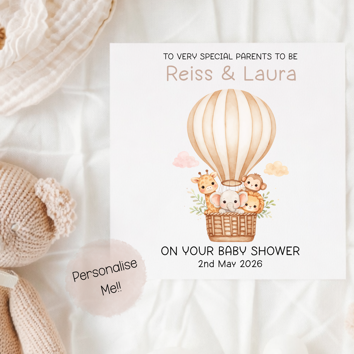 Baby shower invitation with hot air balloon and animals on a soft fabric background