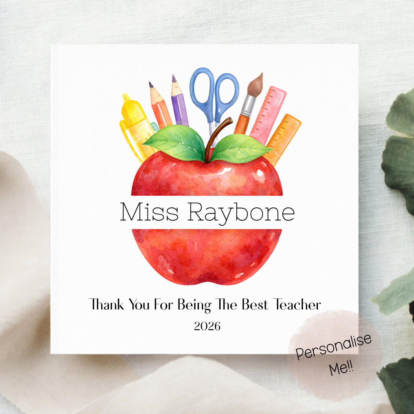 Card with a red apple and school supplies on a white background