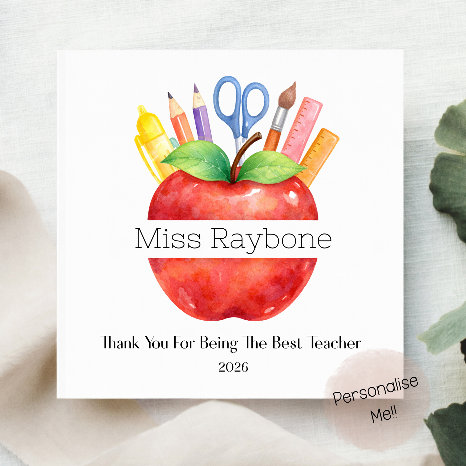 Card with a red apple and school supplies on a white background