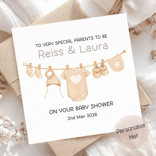 Baby shower invitation card with baby clothesline illustration on a soft background
