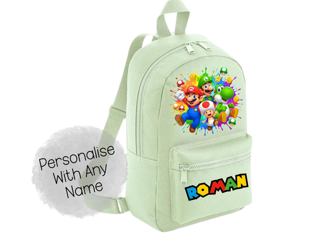 A light mint green backpack featuring a colorful graphic of Mario, Luigi, and other Super Mario characters on the front pocket, with the name 'ROMAN' printed in a multicolor block font below. A grey cloud graphic on the left reads 'Personalise With Any Name'.